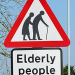 British elderly people crossing road warning sign.